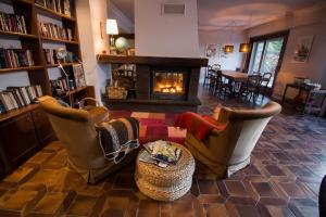a living room with two chairs and a fireplace at Casa Rural Arraigorri in Hernani