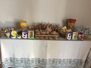 a table with bread and other food items on it at Spagna B&B in Verona