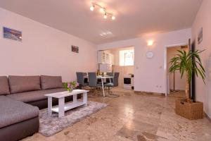 uma sala de estar com um sofá e uma mesa em Apartment Mediteran em Stari Grad