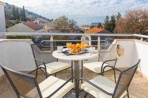 balcón con mesa, sillas y vistas en Agape Duplex Apartment, en Dubrovnik