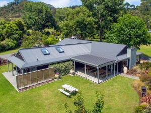 an aerial view of a house with a roof at Flaxmill Accommodation in Whitianga