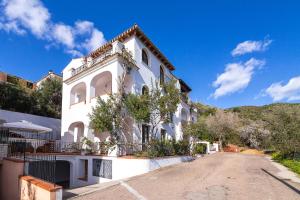 a large white house with a road in front of it at Casa Anna in Santa Maria Navarrese