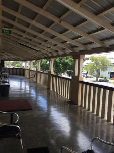 a patio area with a walkway and a bench at Taylors Hotel in Mackay