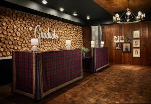 a lobby with wooden walls and wooden logs at Graduate Minneapolis in Minneapolis