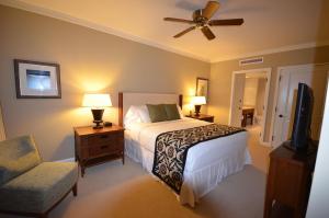 a bedroom with a bed and a ceiling fan at Konea 244 at Honua Kai in Lahaina +19 photos
