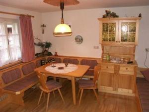 a kitchen with a wooden table and a dining room at Ferien-am-Bauernhof-Wohnung-2 in Rangersdorf