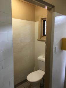 a bathroom with a toilet and a sink at Taylors Hotel in Mackay