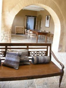 a wooden bench with two pillows sitting in a room at Agriturismo Pian Di Meta Vecchia in Castiglione dʼOrcia