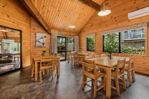 a dining room with wooden tables and chairs at Altamont Lodge in Wanaka