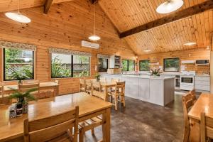 
a kitchen with a table, chairs and a refrigerator at Altamont Lodge in Wanaka

