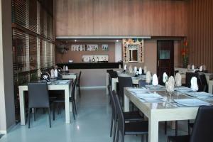 a dining room with tables and chairs in a restaurant at Hotel Santorini Loft in Montería