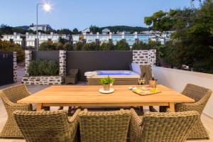 a wooden table and chairs on a rooftop patio at Lakefront Luxury by Amazing Accom in Queenstown