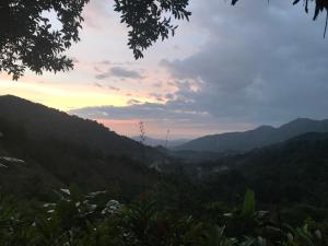 a view of a mountain valley at sunset at Reserva Natural Tierra Adentro in Minca