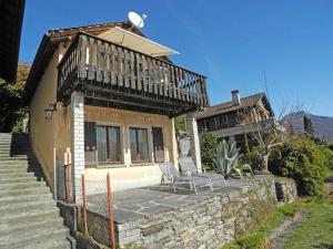 a house with a balcony and a bench on a patio at Casa Baciocca App 1159 in Orselina