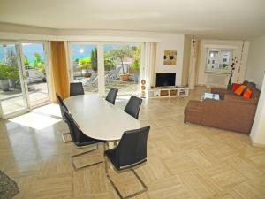 a living room with a table and chairs and a couch at Casa Fontanalba App 1111 in Minusio