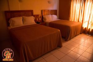 Postel nebo postele na pokoji v ubytování Hotel Gina