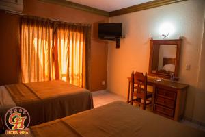 Postel nebo postele na pokoji v ubytování Hotel Gina