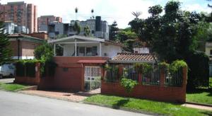 a brick house with a fence in a city at Black Sheep Medellin in Medellín