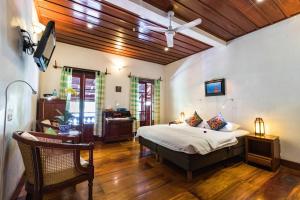 a bedroom with a bed and a desk in a room at Mekong Riverview Hotel in Luang Prabang