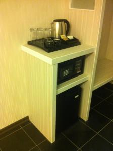 a kitchen with a stove with a tea pot on it at Venus Boutique Hotel in Melaka