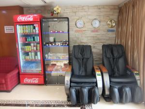 twee stoelen voor een cocacola machine bij YaJu Hotel in Singapore