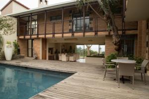 a house with a pool and a wooden deck at Misty Blue Bed and Breakfast in Durban