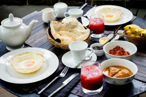 a table with plates of food and drinks on it at Mount Lodge Boutique Hotel in Mount Lavinia +31 photos