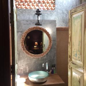 a bathroom with a round sink and a mirror at Baan Nai Nakhon in Songkhla