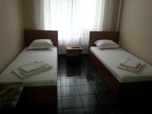 A bed or beds in a room at Kanclera Hotel