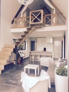 a living room with a staircase and a table at Dream house in Poperinge