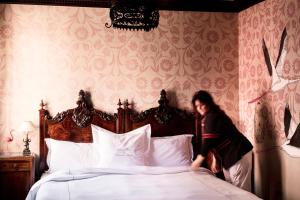 Posteľ alebo postele v izbe v ubytovaní Novecento Boutique Hotel