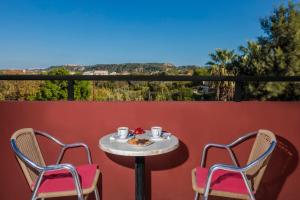 a table and chairs on a balcony with a view at Alea Hotel Apartments in Ialysos