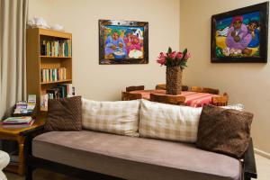 a living room with a couch and a table at Island View f5 in Melkbosstrand