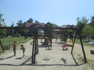 a group of children playing in a playground at Fenyves Villa in Balatonfenyves