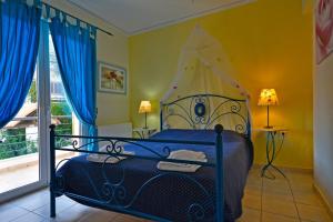 a bedroom with a bed with a canopy at Villa Dolphins in Poros
