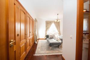 a living room with a couch and a window at Grace Villa in Aldeia de Juso