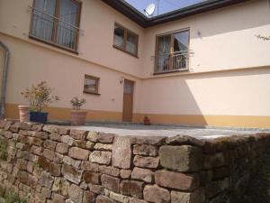 a stone retaining wall in front of a house at Ferienwohnung Barzen in Ralingen