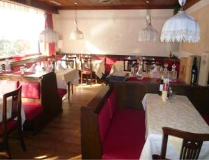 een restaurant met tafels en stoelen in een kamer bij B&B Hotel Dolomiti in Bolzano