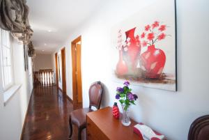 a room with a table with vases on the wall at Grace Villa in Aldeia de Juso