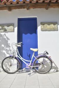 a bike parked in front of a blue door at Villa Dolphins in Poros