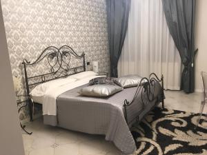 hotel alla busa في Noventa Vicentina: غرفة نوم بسرير أسود عليها وسائد