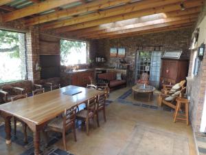 a living room with a wooden table and chairs at MacNut Bed and Breakfast in Nelspruit