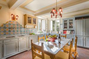 a kitchen with a table and some chairs and a table at Coselli 's Collection. Luxury Villas Rental in Capannori