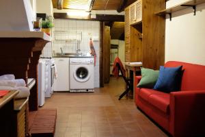 sala de estar con sofá rojo y lavadora en Castiglione Lovely Mansarda en Bolonia