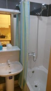 a bathroom with a sink and a shower next to a toilet at Apartments Darvina 20, Апартаменты на улДарвина дом 20 in Kharkiv