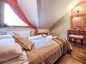 a bedroom with a large bed and a window at VisitZakopane - Malibu Apartment in Zakopane