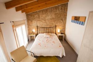 a bedroom with a bed and a table at L'Hostal Pollença - Turisme Interior in Pollença