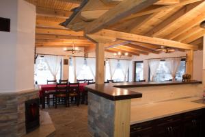 a kitchen and dining room with a bar in a house at Guest House Ivan in Cherni Osŭm