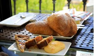 two plates of bread and pastries on a table at Hotel Corallo Sperlonga in Sperlonga