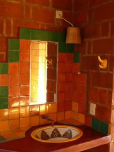 a bathroom with a stone wall and a fire place at La Loma Linda: Bungalows, Yoga and Feldenkrais in Zipolite